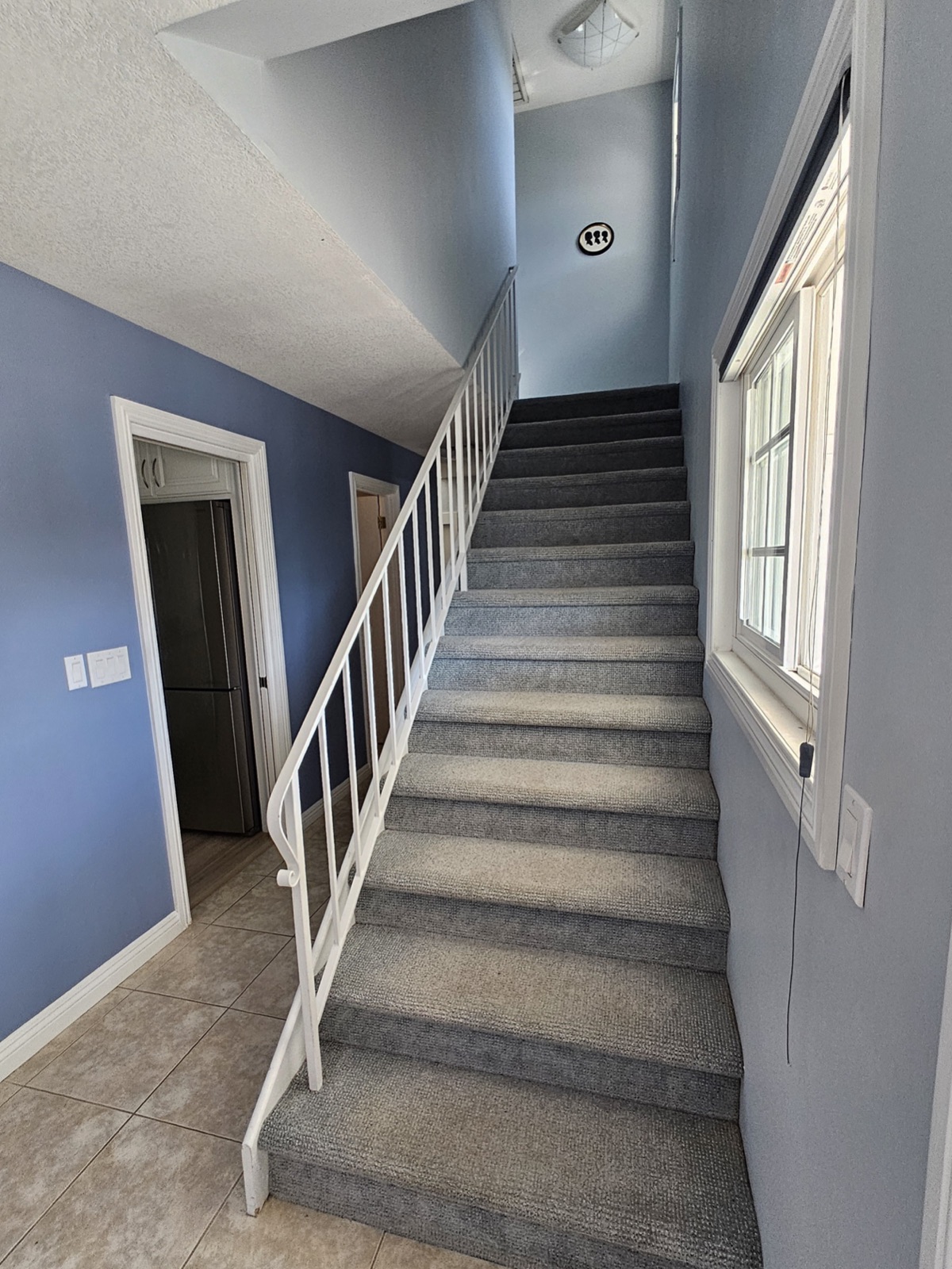 Before: carpeted staircase with a dated white railing