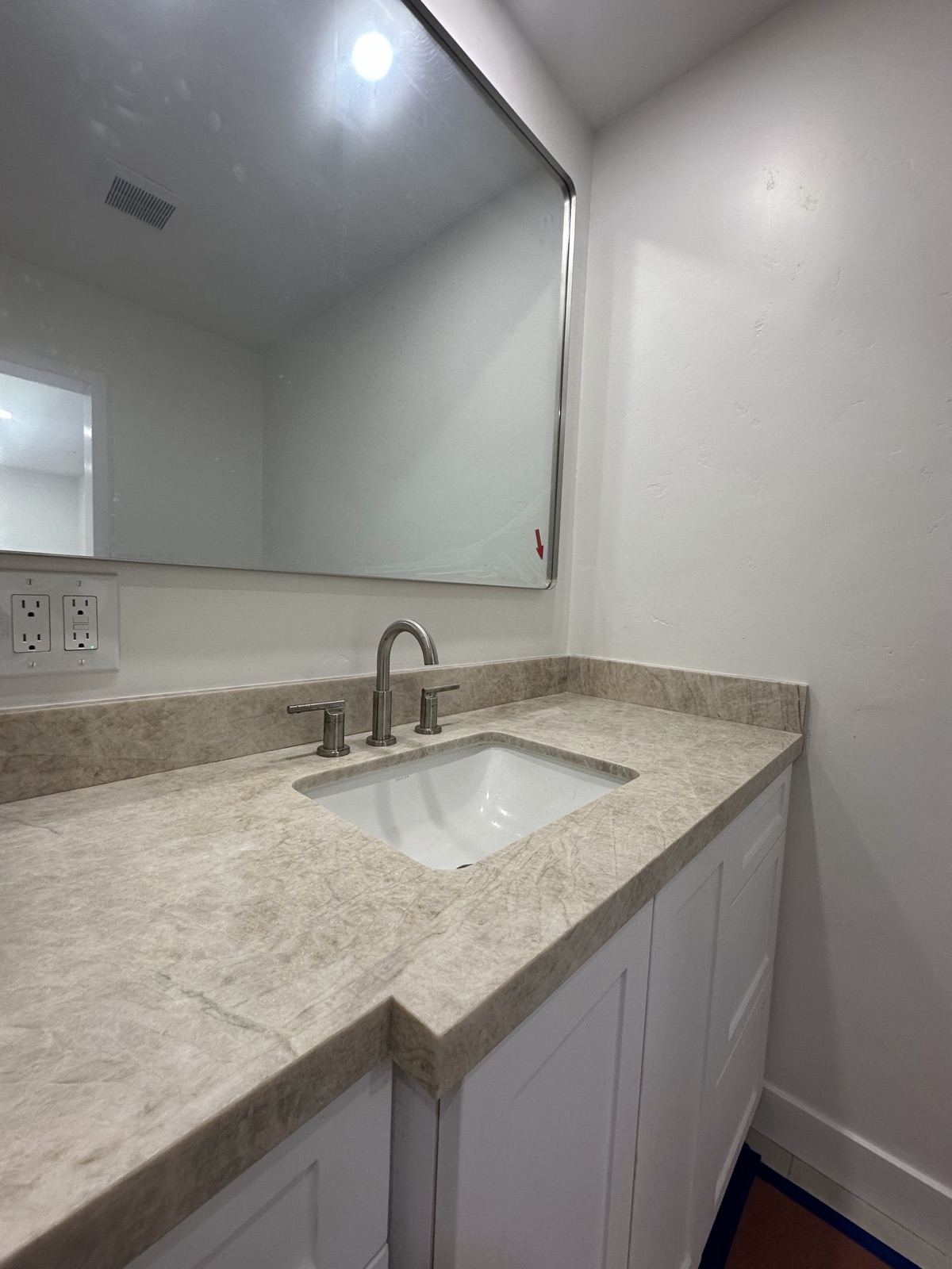 Custom vanity with stone countertop in the remodeled Oceanside bathroom