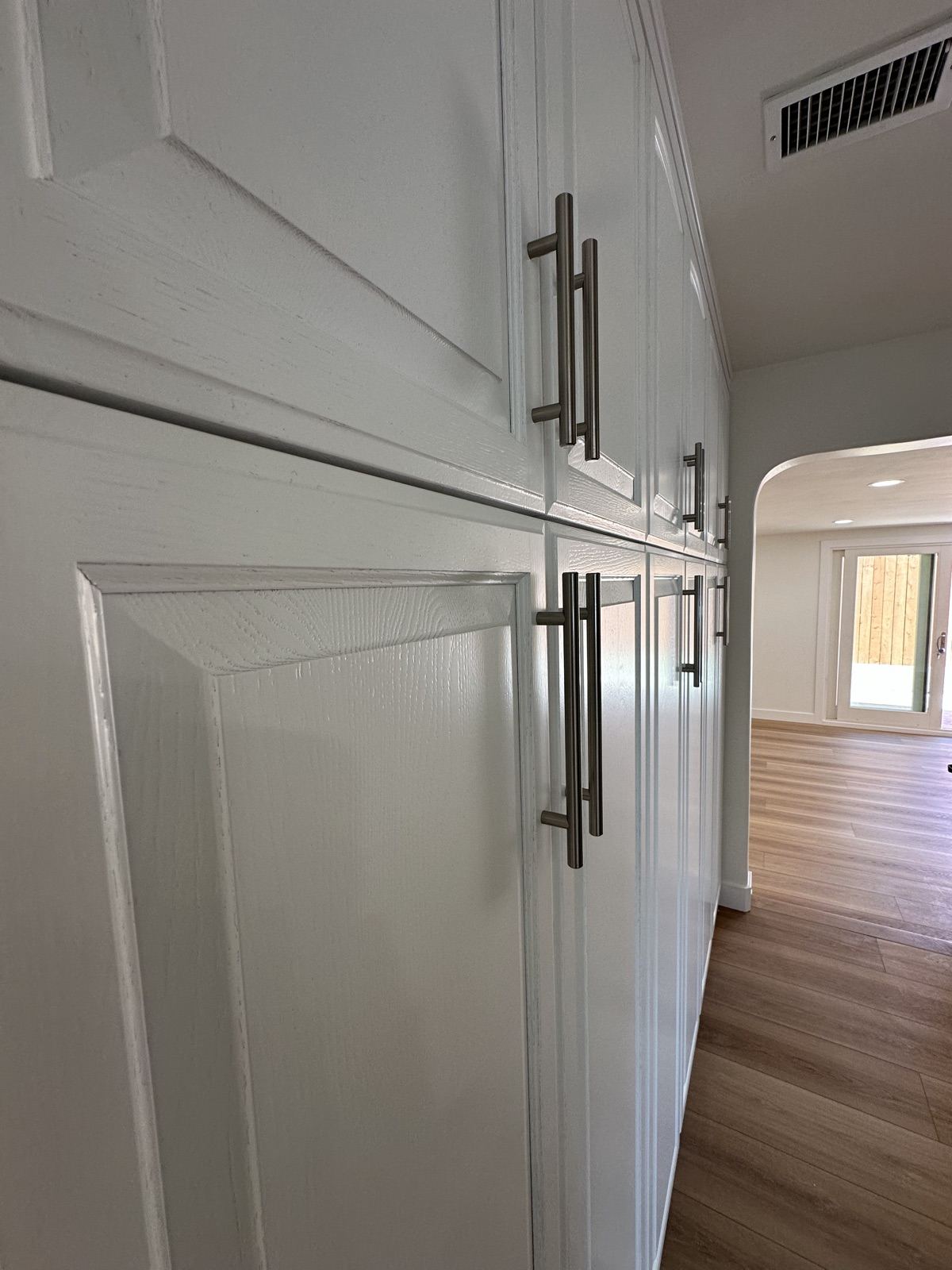 Custom white cabinetry installed during the Oceanside remodel