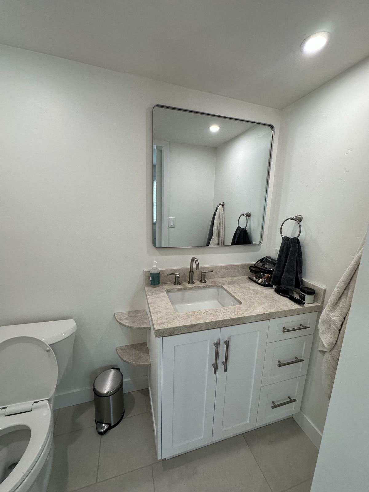 Remodeled powder bathroom with new vanity and mirror in Oceanside