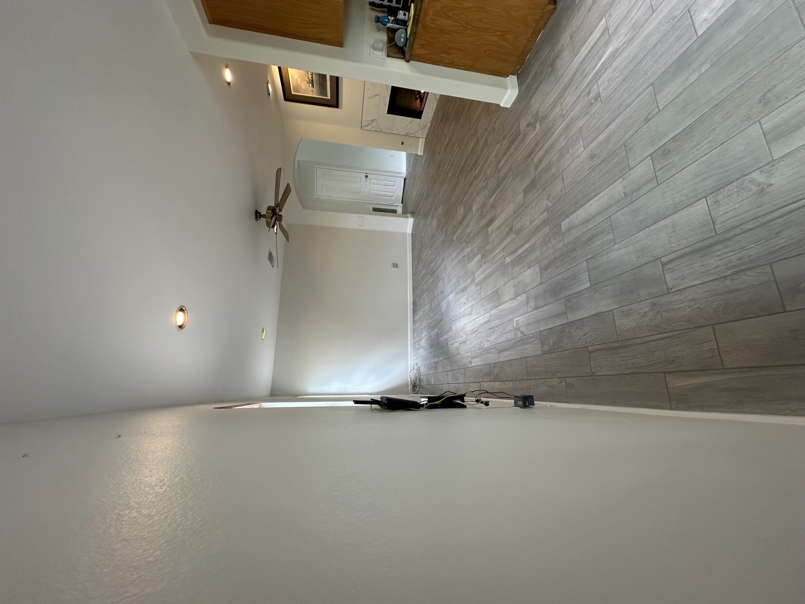 Open living area with new tile flooring flowing toward the kitchen in Poway
